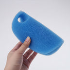 Blue foam sponge held by a hand on a white background