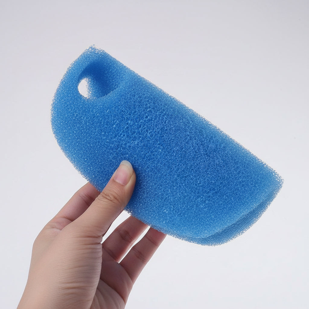 Blue foam sponge held by a hand on a white background