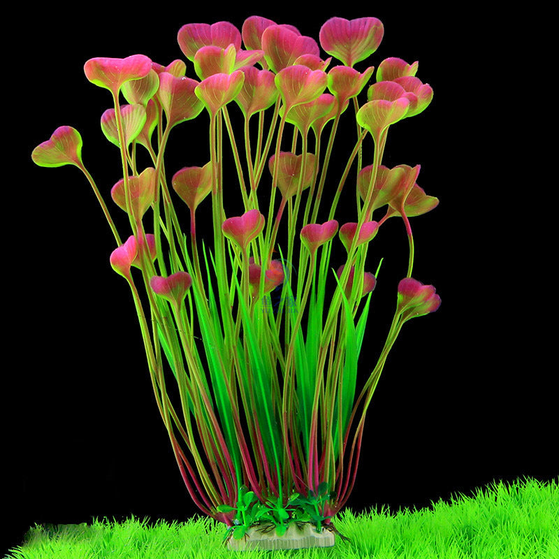Artificial aquarium plant with pink and green leaves on a black background