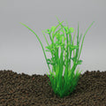 Green artificial aquarium plant on a black background