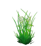 Artificial green plant with white flowers on a black background