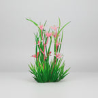 Artificial aquarium plant with pink flowers and green leaves on a black background