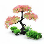 Artificial aquarium plant with pink and green leaves on a white background