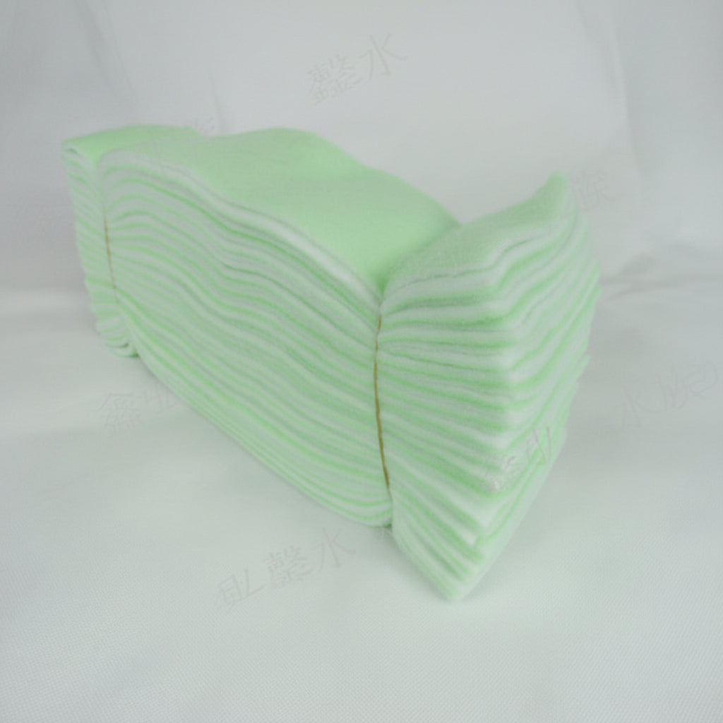 Stack of green paper towels on a white background