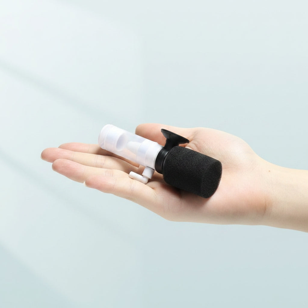 Hand holding a small black and white device with text about its compact size.