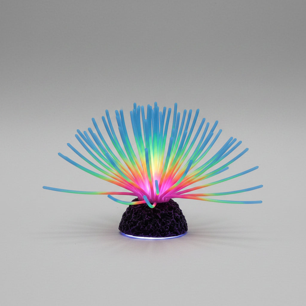 Colorful artificial coral in an aquarium with text about reliable silicone material.